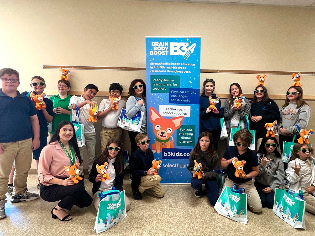 Picture of classroom and SH in a hallway with Doug the Dog stuffed animal