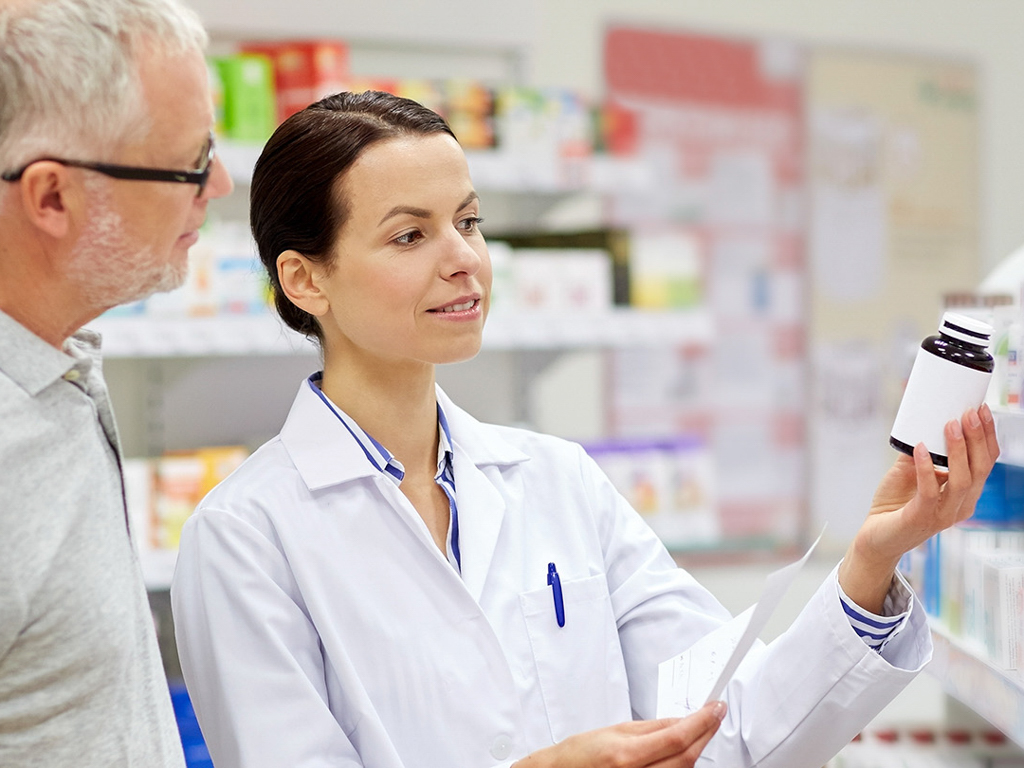 Pharmacist showing medication to a patient