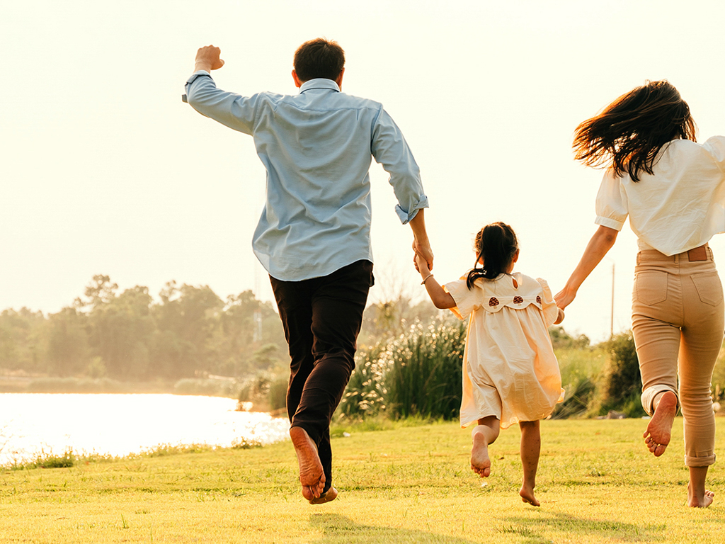 A family running on the grass together