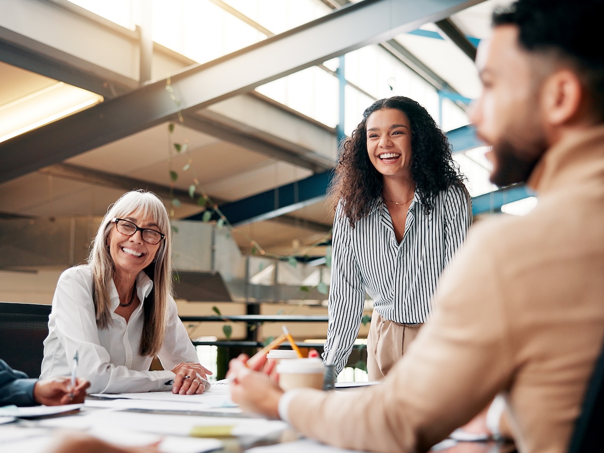 Brainstorming, speaker and woman in boardroom, laughing and brand specialist with ideas for project. Business, creative and people with strategy for target audience, trends and speech for workshop.
