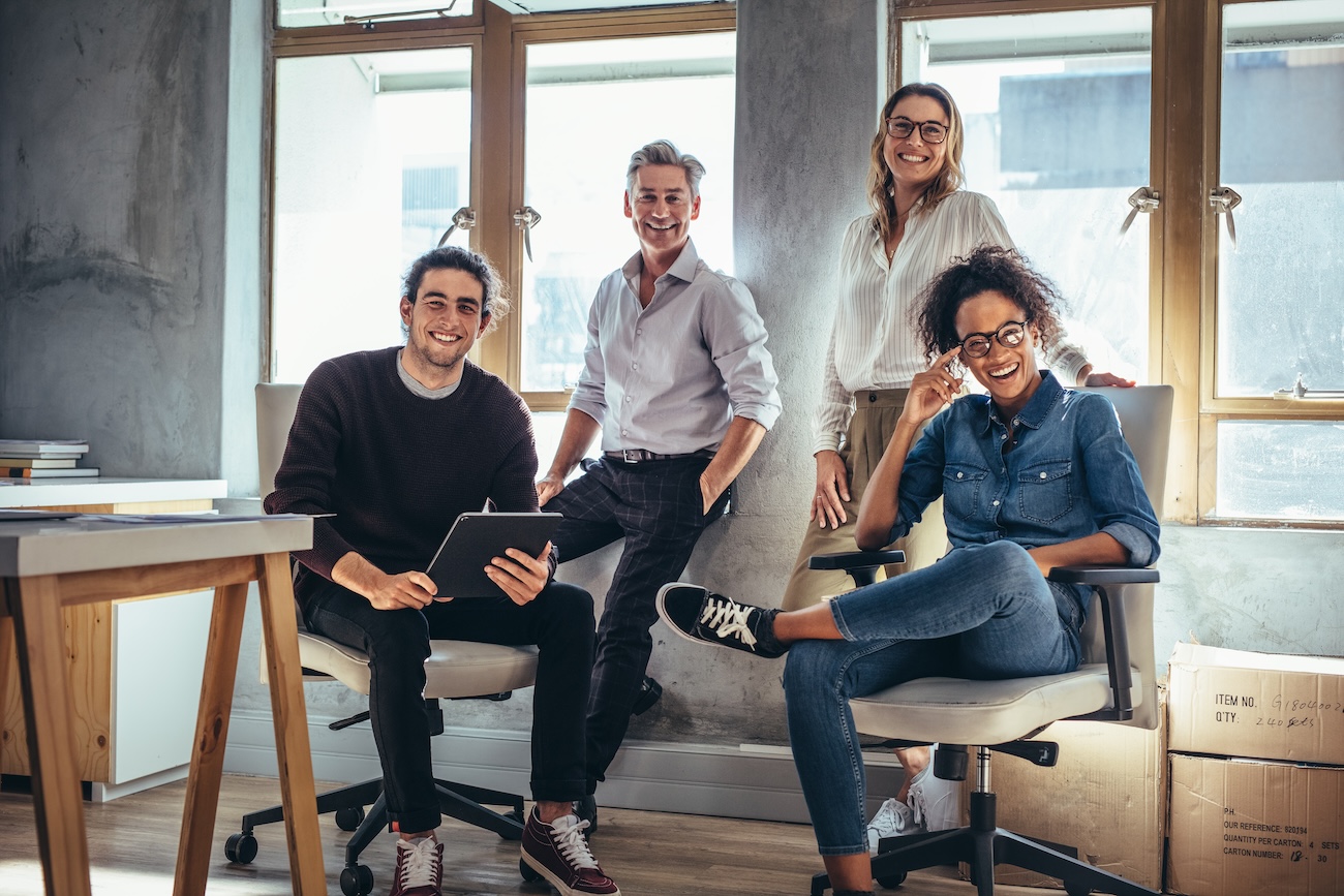 Portrait of successful group of people working at online web store. Men and women at ecommerce business office.