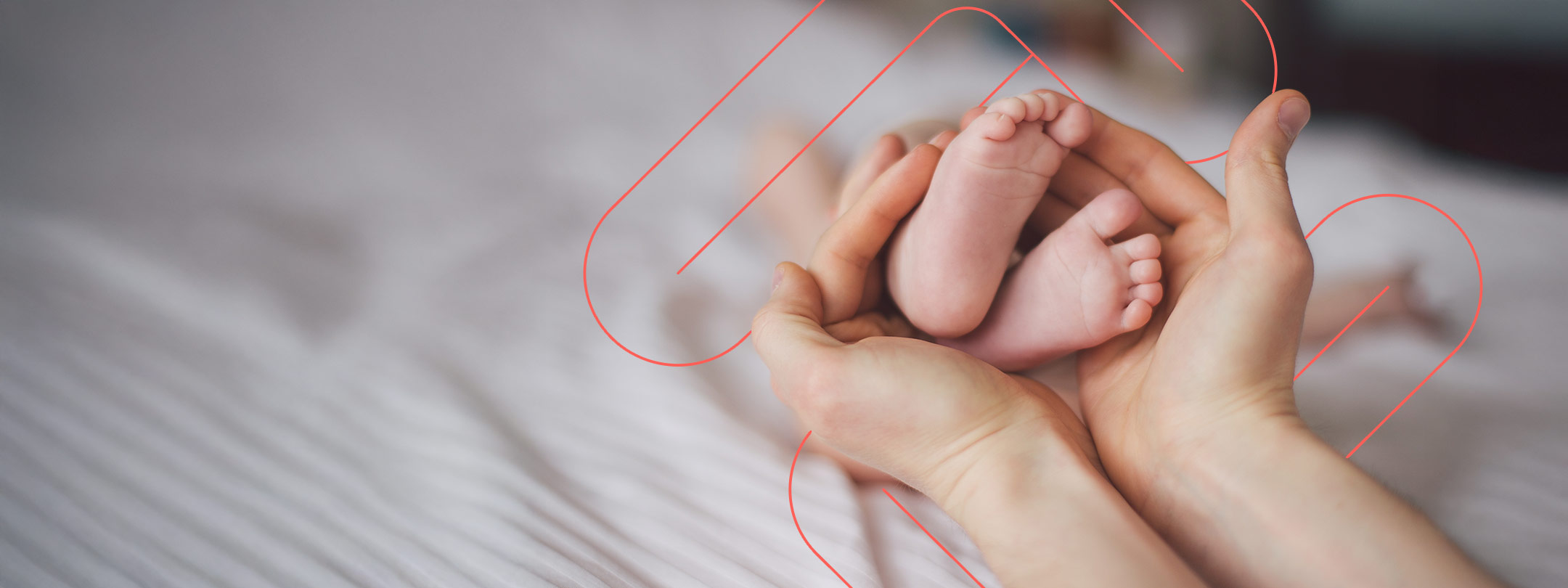 Photo of a parent's hands holding their newborn baby's feet