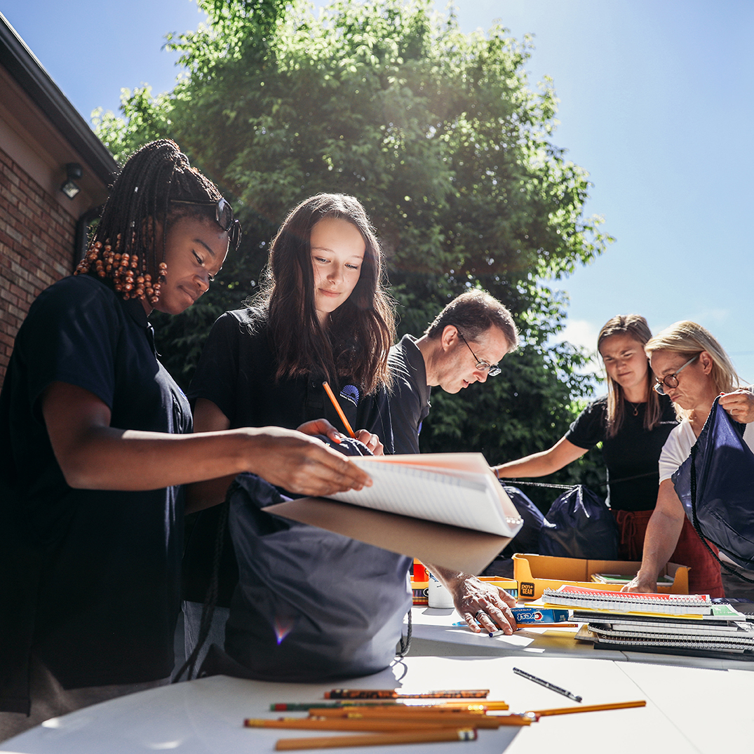 Students getting supplies at a back to school event