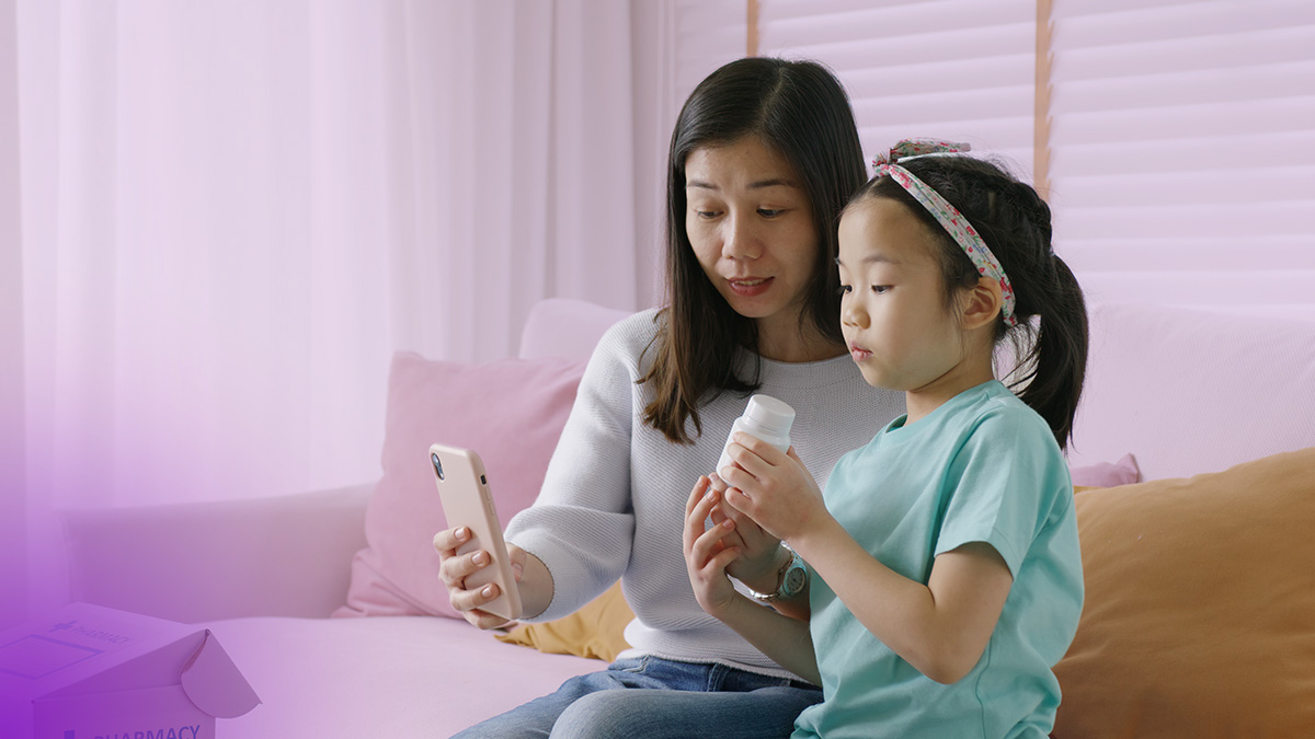 Mom and daughter on a couch having a virtual doctor's visit