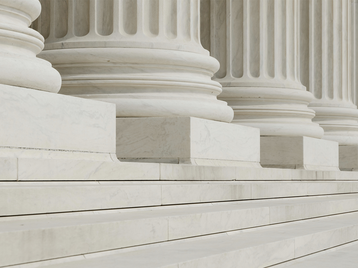 close up picture of the steps and pillars of a white government building
