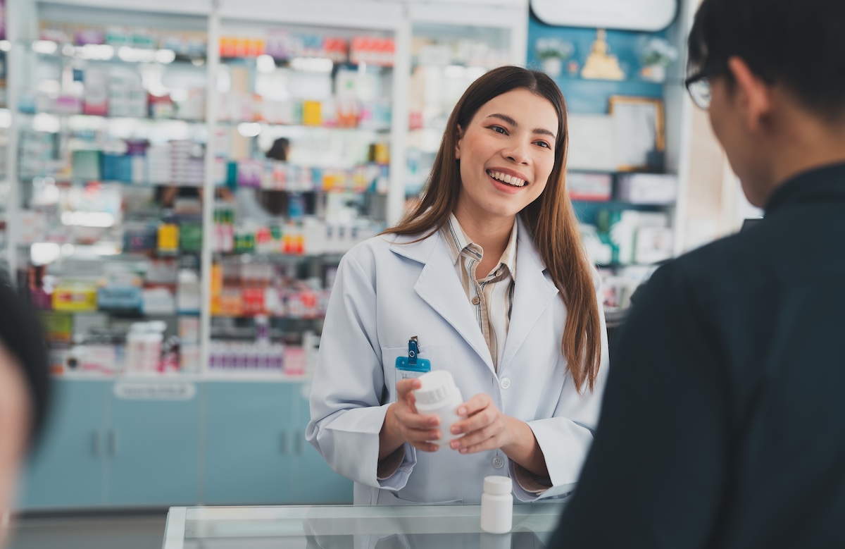 female pharmacist at drugstore.Health care pharmacists work at the hospital.Pharmacist looking at male customer.Doctor specialists organize prescription medications.