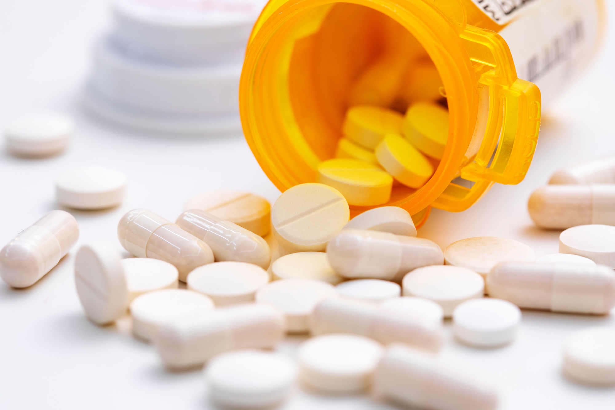 Prescription pills spilled out on a table.