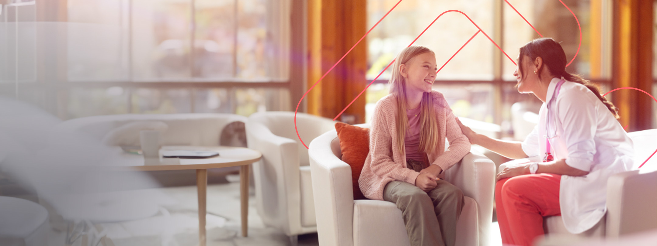 Doctor in a lobby sitting and talking with a young female patient