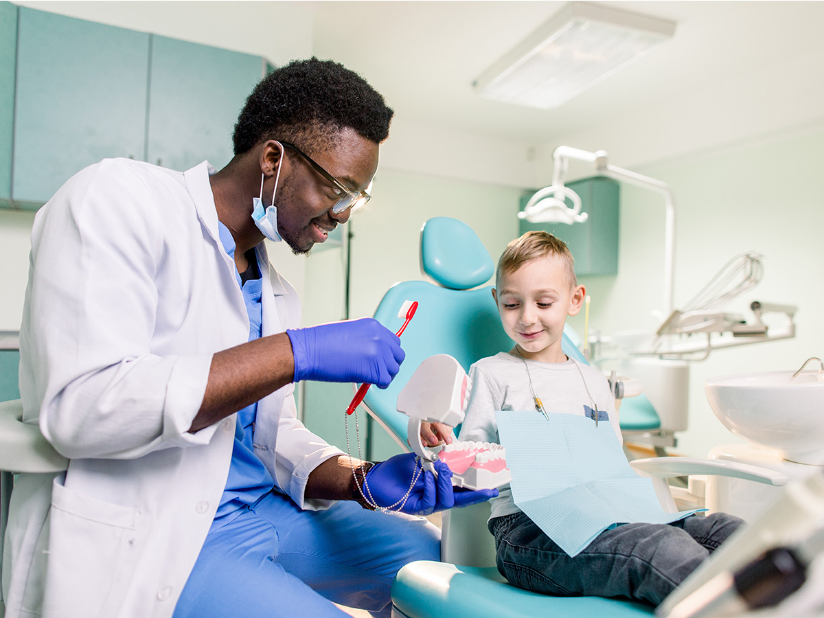 Child sitting in a dentist chair for a dental cleaning