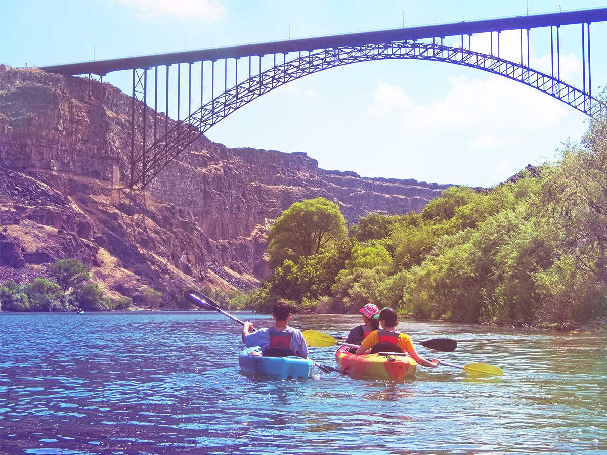 A group of three kayaking a river in Idaho