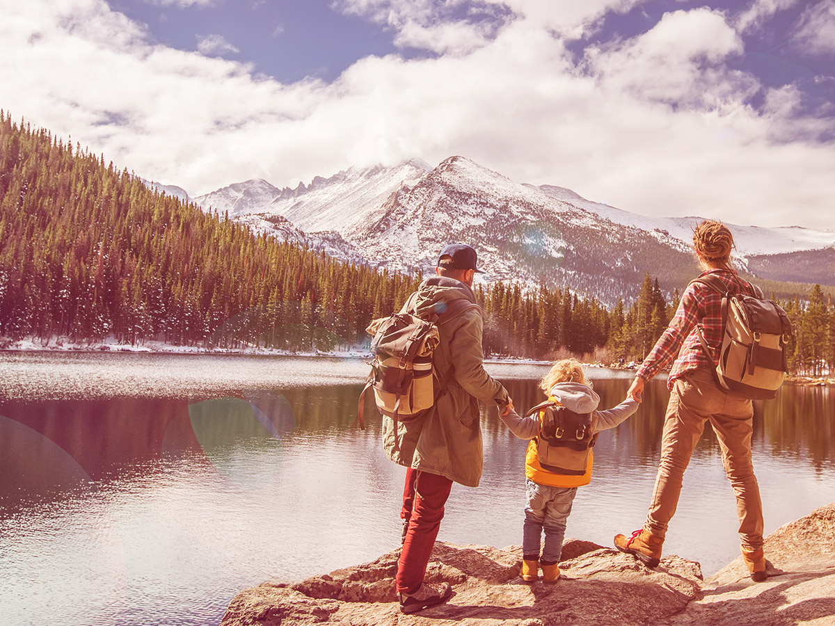 A family of three hiking the Rocky Mountains in Colorado