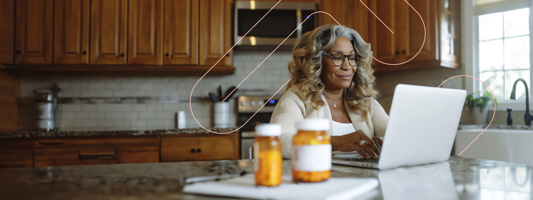 Woman looking at her laptop with medications in the foreground